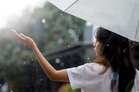 back-view-woman-enjoying-rain-while-holding-umbrella1