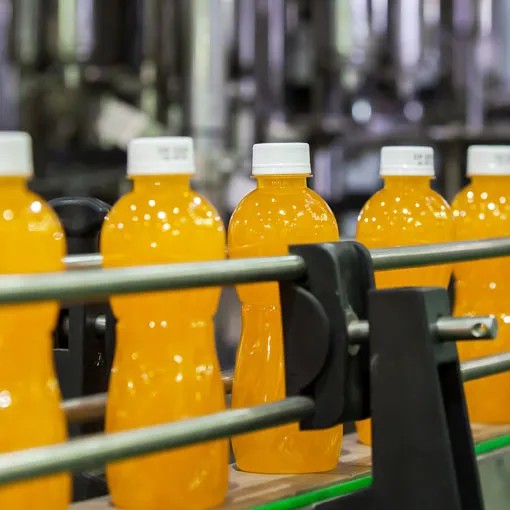 bottles-of-orange-drink-on-a-production-line