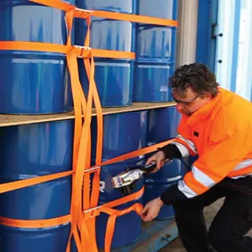 man-securing-chemical-drums-in-a-container-using-cornerlash-system