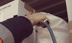 man-using-cordstrap-digital-fast-inflator-on-a-dunnage-bag