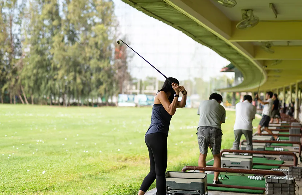 asian-woman-practicing-his-golf-swing-golf-driving-range