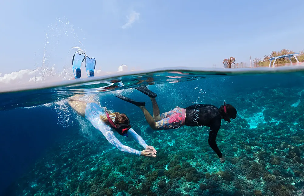 woman-man-snorkel-underwater-with-mask-fins-ocean-together