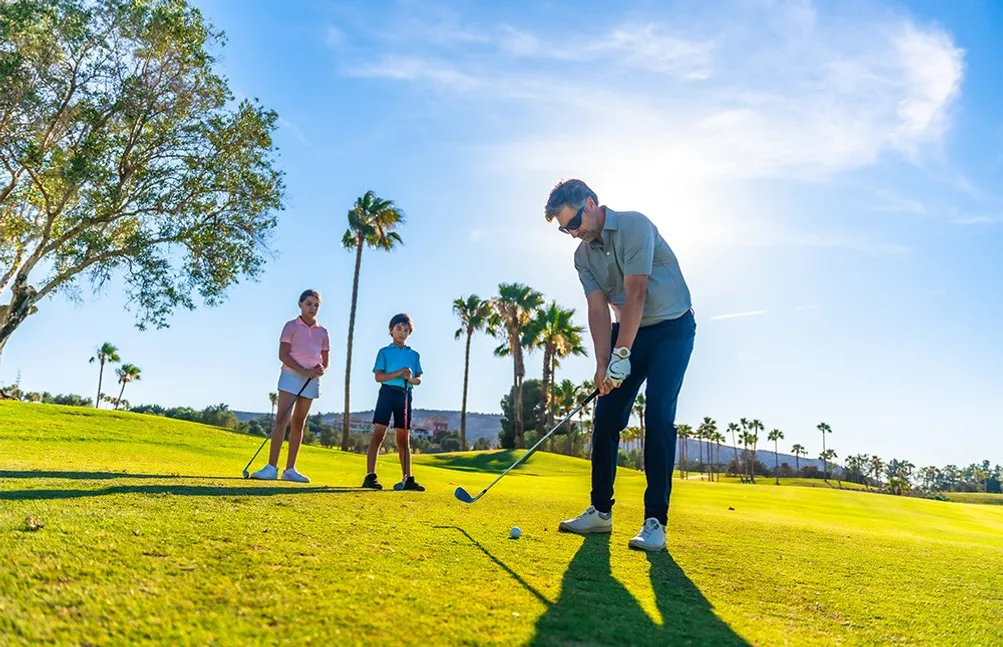 man-teaching-how-swing-golf-two-children1009424556873