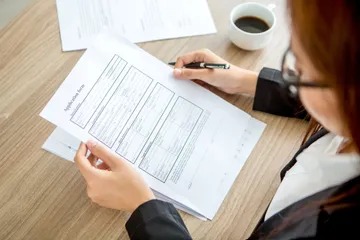 young-businesswoman-reading-application-form
