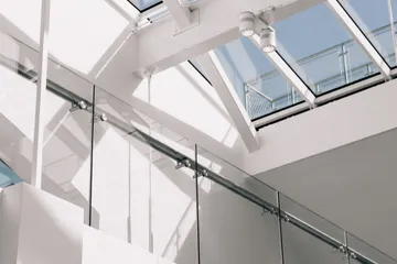 low-angle-shot-modern-building-interior-with-white-walls-touching-sky