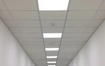 white-ceiling-with-pvc-tiles-lighting-indoors-low-angle-view