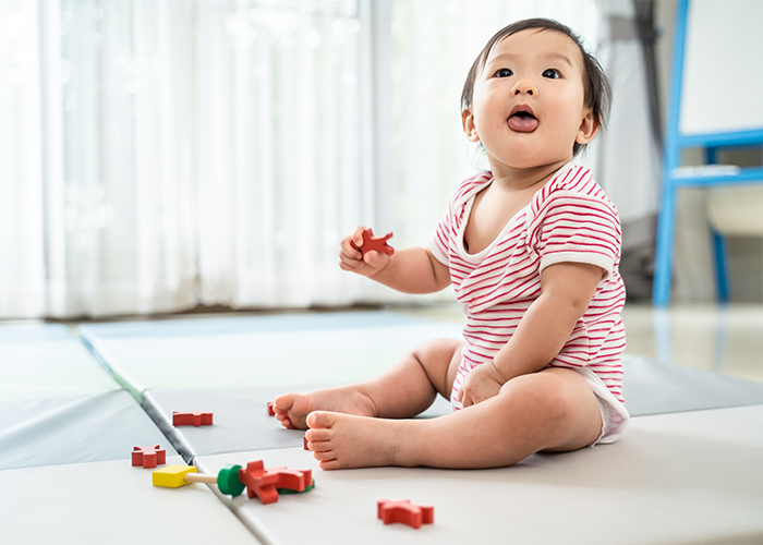 play0004asian-cute-baby-sitting-playing-small-toy-soft-mat-home
