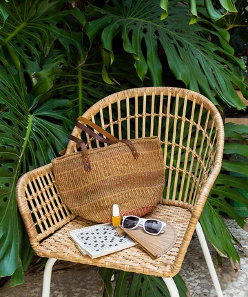 straw-chair-travel-items-arrangement