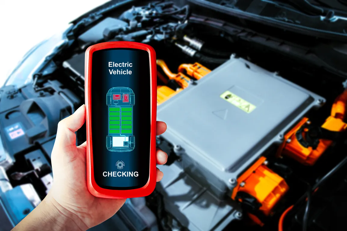 car-technician-checking-electric-vehicle-system-problems-with-wireless-scan-tool