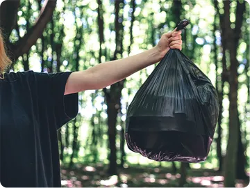 closeup-bag-garbage-blurred-background-forest(1)