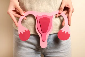 woman-holding-reproductive-system-front-view