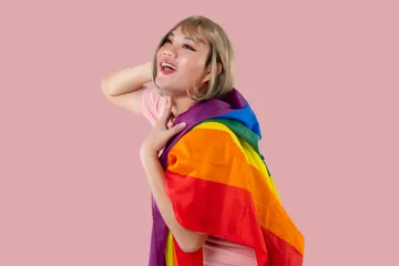 young-asian-transgender-lgbt-with-rainbow-flag-isolated-pink-color-background-gender-expression-pride-equality-concept(1)