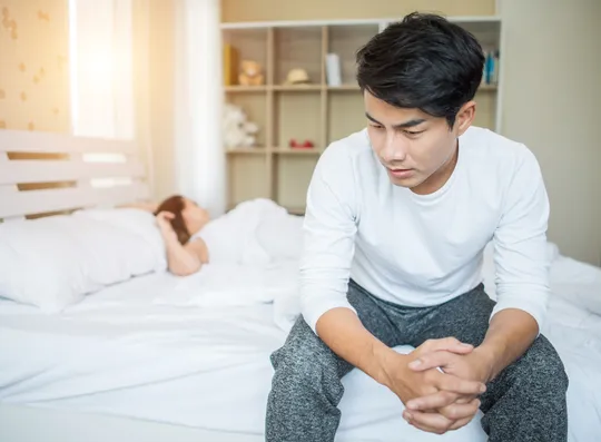 upset-man-having-problem-sitting-bed-after-arguing-with-his-girlfriend(1)
