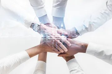 business-team-joining-hands-together-city-background